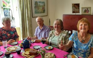 Devizes U3A members around a table with coffee and cake